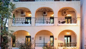 A building with three balconies, each with a wrought iron railing and a small window. - Central Apt With Hydromasage Shower (Hersonissos)