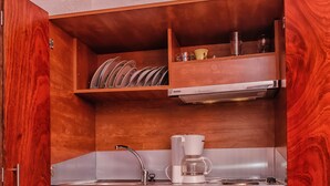 A compact kitchen with a built-in sink, a coffee maker, and a mini refrigerator. - Cozy Studio in Hersonissos Center (Hersonissos)