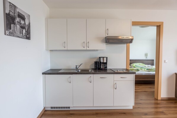 Fridge, stovetop, dishwasher, coffee/tea maker