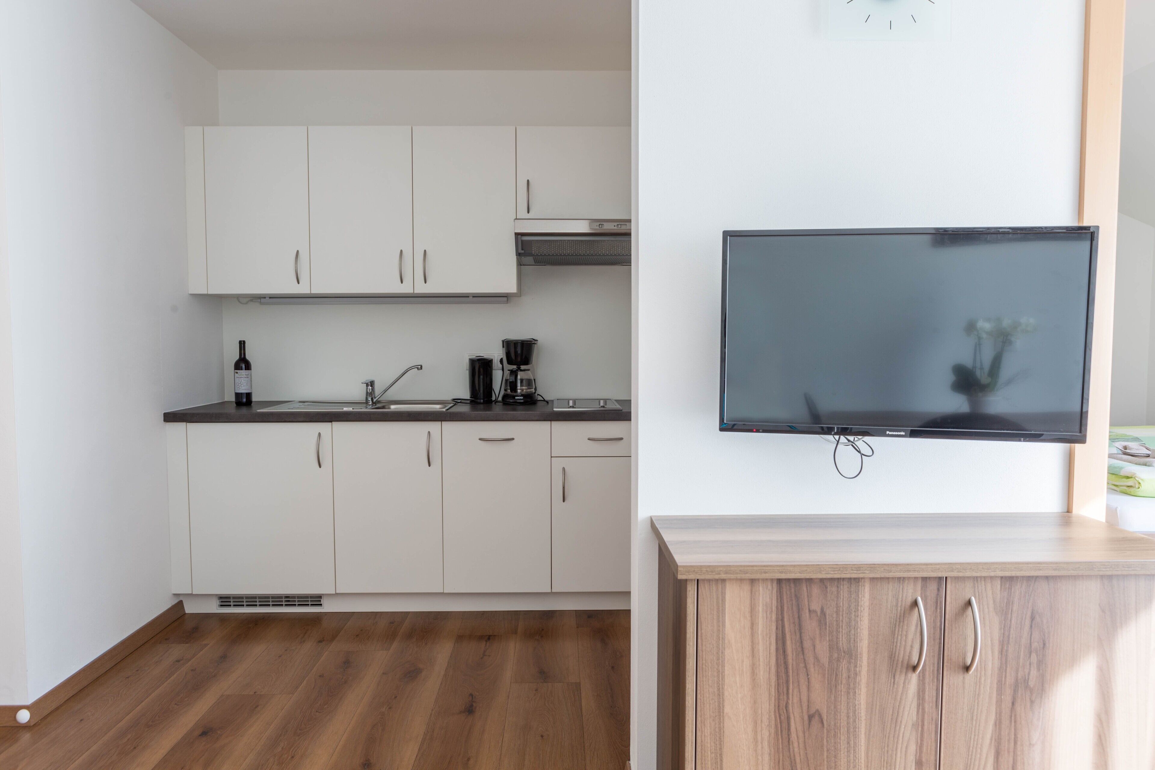 Fridge, stovetop, dishwasher, coffee/tea maker