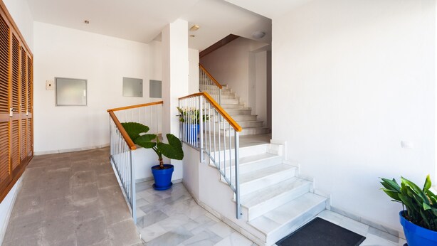 A staircase with white steps and wooden railings, leading to an upper floor. - Spacious Holiday Apartment "Duplex A Fontanilla" Near the Beach (Conil de la Frontera)