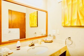 A bathroom with a sink, mirror, towel rack, and a door. - Room-superior Comfort Room With Swimming (Playa del Carmen)