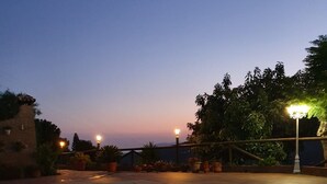 A swimming pool with a tiled edge, surrounded by potted plants and a stone wall. - Peaceful Home Cortijo La Rijana with Pool, Terrific Views, Terrace, Wi-Fi (Sayalonga)