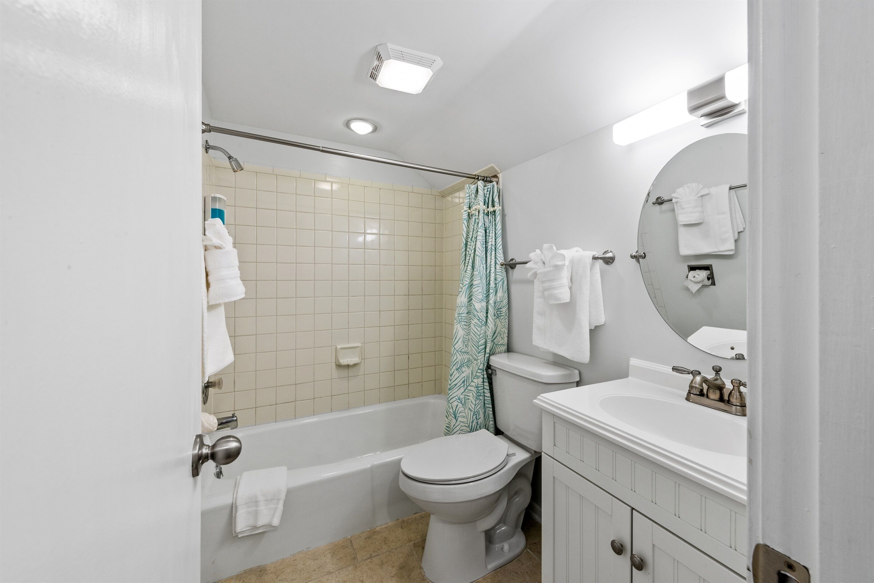 A bathroom with a bathtub, toilet, and sink.