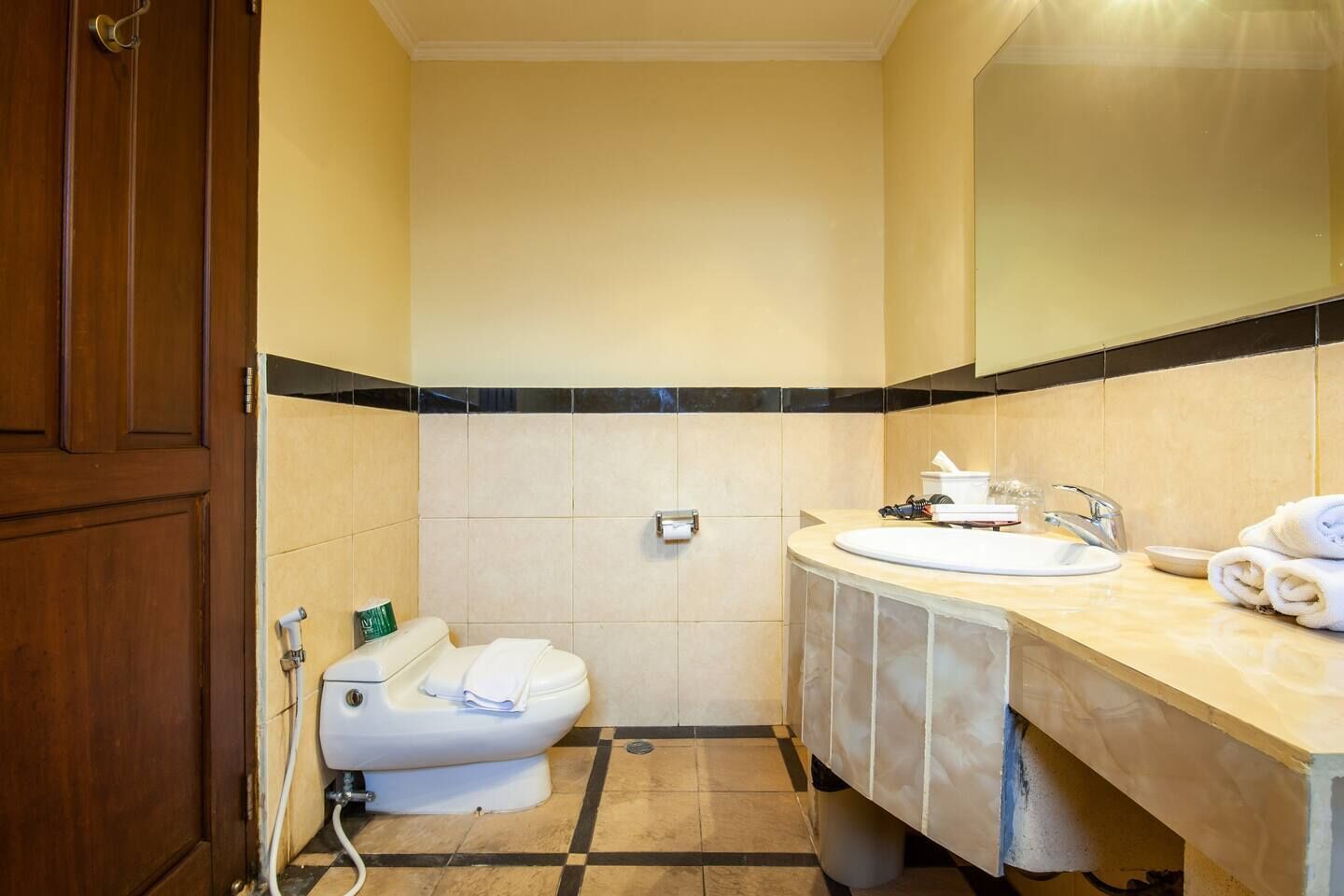 Ein Badezimmer mit Toilette, Waschbecken und Spiegel.