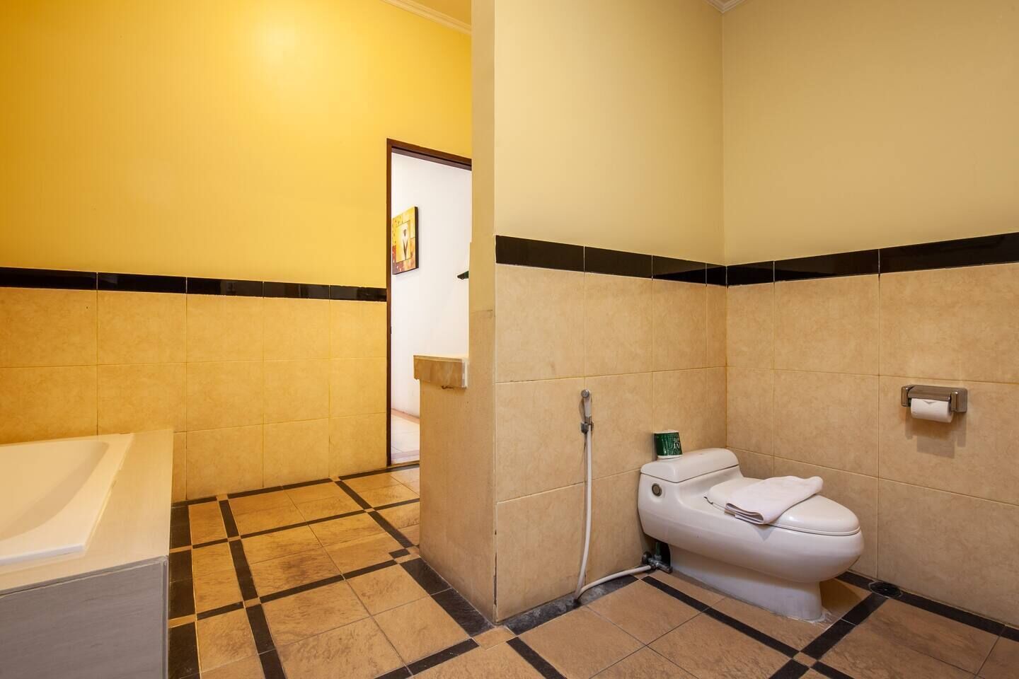 A bathroom with a toilet, sink, and shower area.