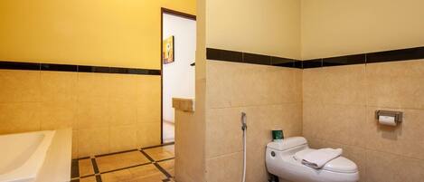 A bathroom with a toilet, sink, and shower area.