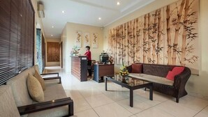 A spacious lobby with a reception desk, a sofa, and a coffee table.