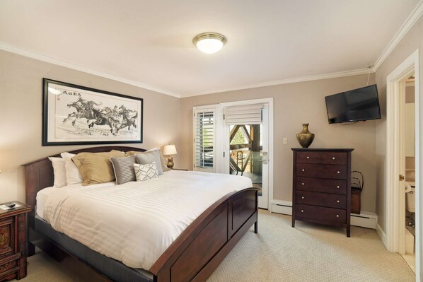 A bedroom with a large bed, a dresser, a TV, and a framed picture on the wall. - Aspen Condo 1.5 Blocks to Town. Balcony. Outdoor Pool. Sleeping Den w/Sofa Bed, 3 Bathrooms, Gas FP (Aspen)