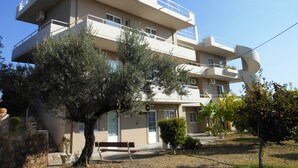 A multi-story building with balconies, a central courtyard, and surrounding vegetation. - Villa Olive Grove,superior Studio (Rhodes)