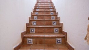 A staircase with brown steps and blue decorative tiles. - Villa Blumarine (San Vito Lo Capo)