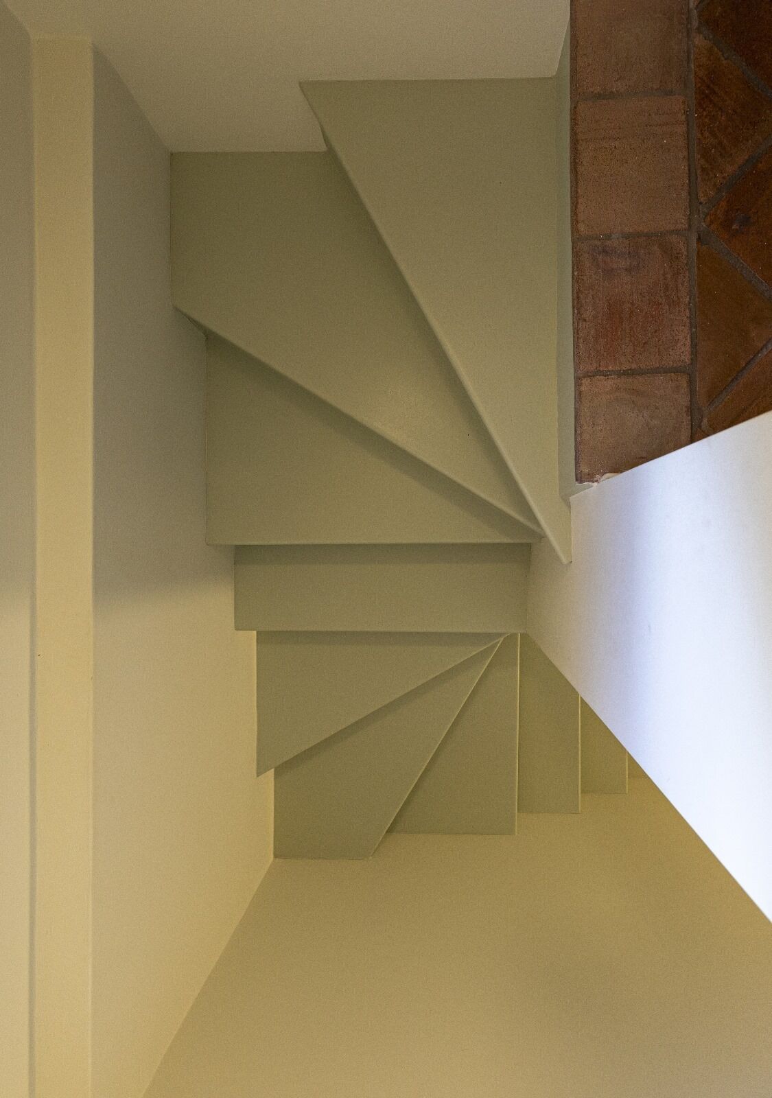 A staircase with a geometric design, leading to a tiled area.