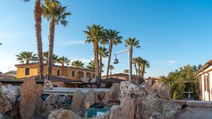 A residential area with palm trees, a street lamp, and houses with balconies. - Centrally Located, Mediterranean Holiday Apartment with Garden and Terrace; Pets Allowed (san teodoro)