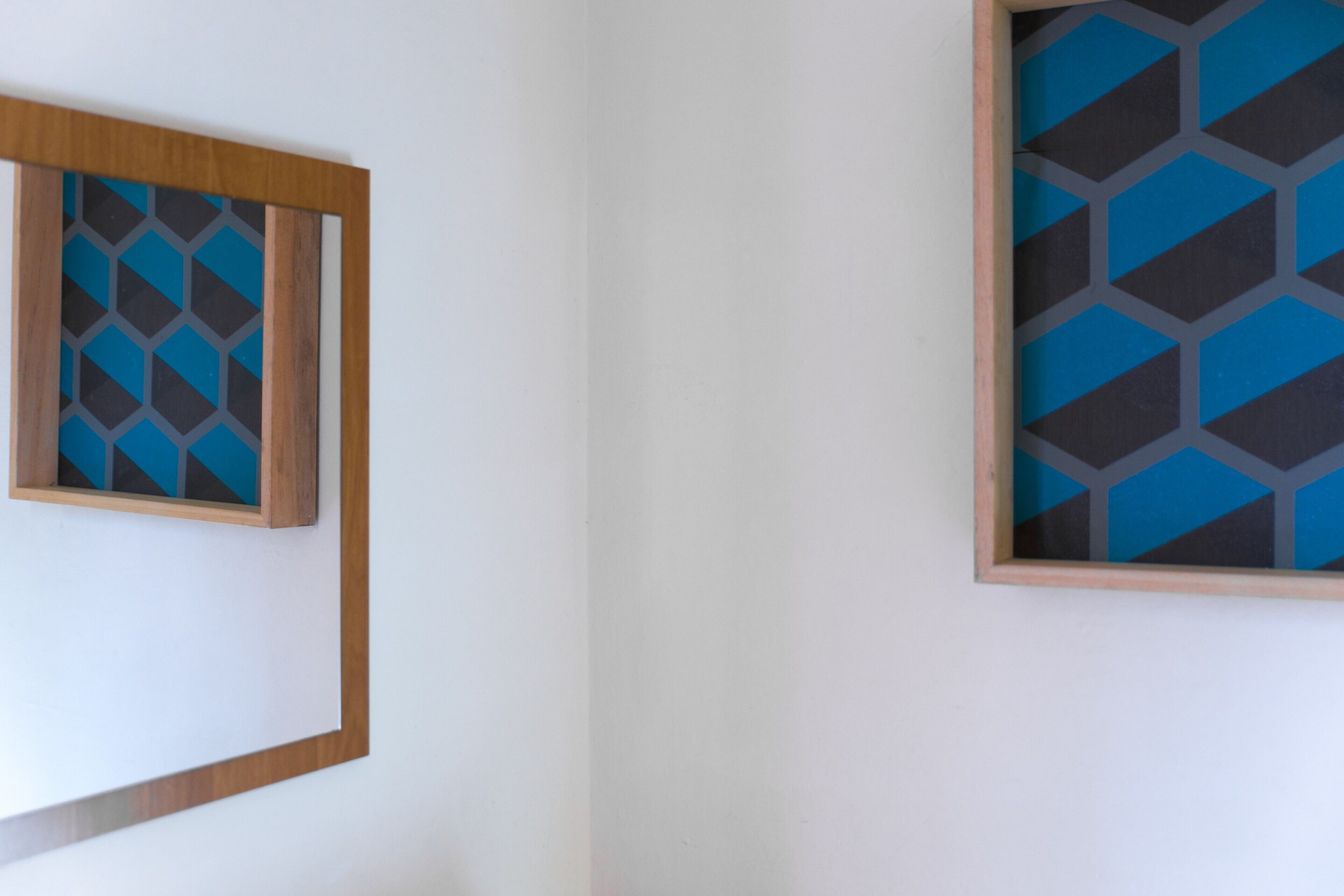 Two framed wall art pieces with geometric patterns.