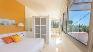 A bedroom with a bed, a window, and a view of the outdoors. - Stunning villa with pool & sea view – Villa Maitreya (san jaime, son bou, Alaior)