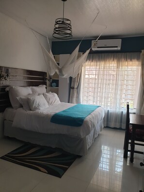 Family Apartment, Kitchenette, Garden Area | Down comforters, desk, laptop workspace, blackout drapes - Jedidiah Guest House (Kitwe)