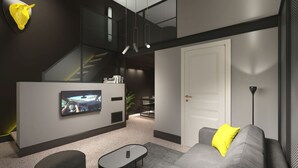A modern living room with a grey sofa, a coffee table, and a TV mounted on the wall. - 18 · Extreme design style - Bologna Downtown Apartment (Bologna)