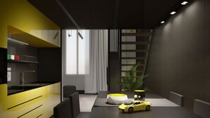A modern living room with a minimalist design, featuring a black and yellow color scheme, a dining table, a yellow sports car model, and a large window with curtains. - 18 · Extreme design style - Bologna Downtown Apartment (Bologna)