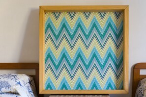 A framed zigzag pattern artwork on a wall.