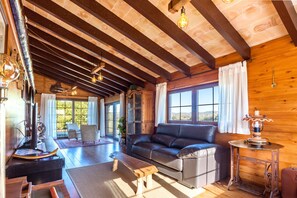Un intérieur en bois avec un canapé en cuir, une table en bois et un banc.
