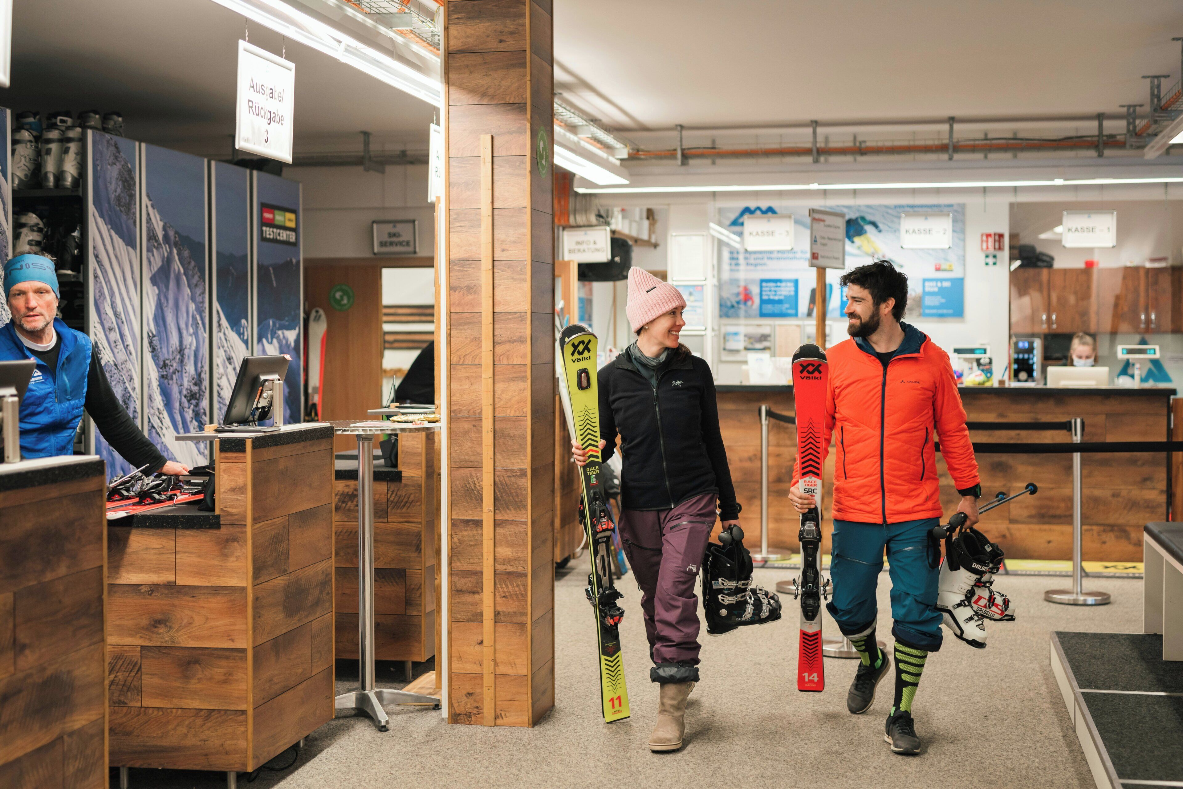 A ski rental shop with wooden counters and ski equipment.