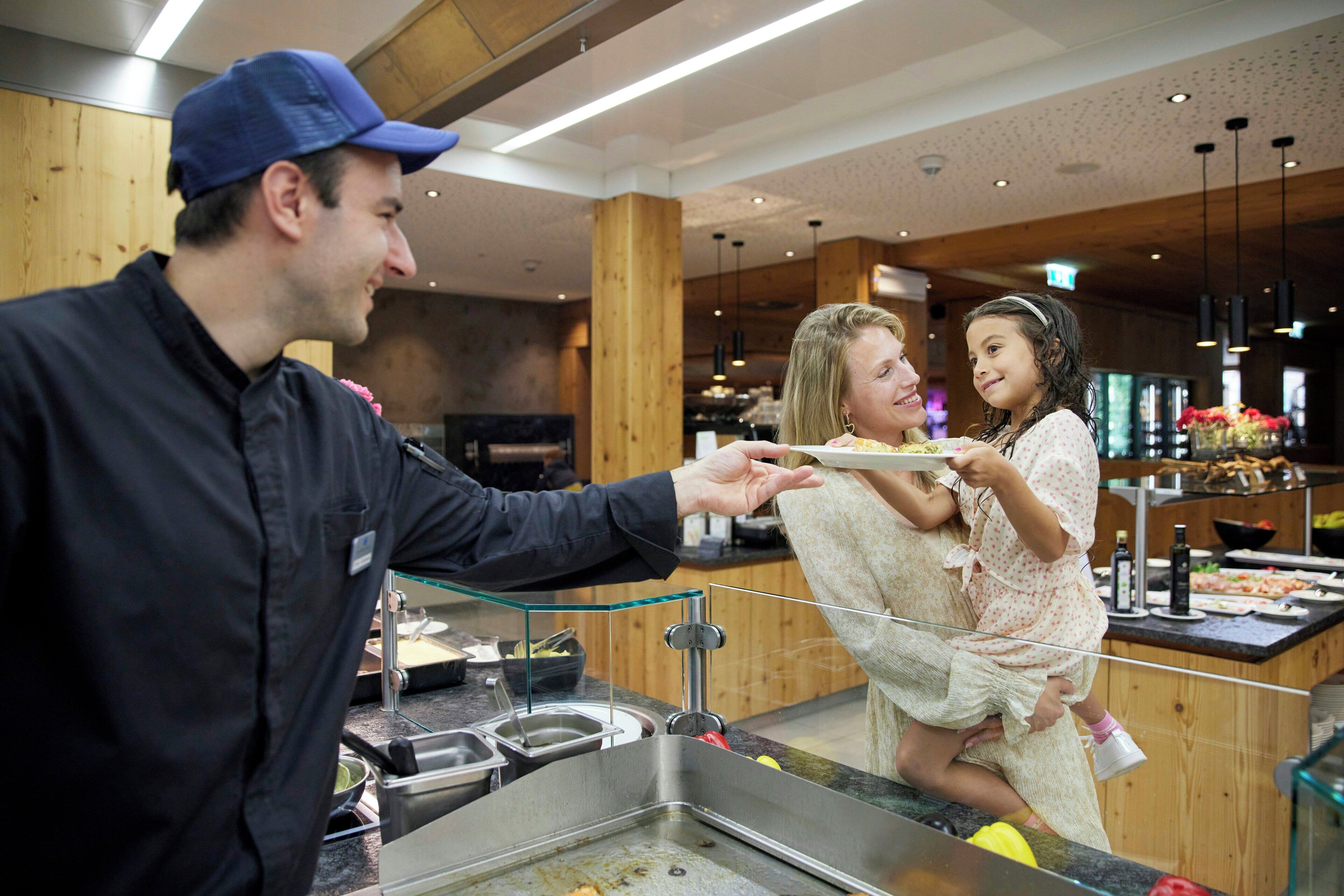 A buffet area with a variety of food options and a service counter.