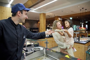 A buffet area with a variety of food options and a service counter.