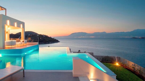 A modern infinity pool with a view of the sea and distant mountains. - Welcome to Villa Soligia! Beach Front Villa Large Private Pool Amazing Sea View (Corinth)