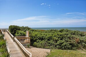 A wooden boardwalk leading to a beach with dense greenery and a clear view of the ocean. - Beautifully Updated Oceanfront Condo w/ wine fridge (North Topsail Beach)