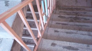 A staircase with a metal handrail and concrete steps. - Desmak Hotel (Isiolo)