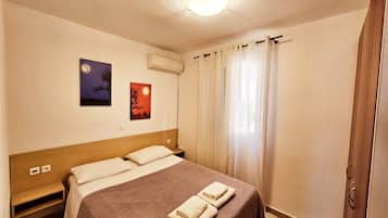 Apartment, 1 Bedroom, Garden View | 2 bedrooms, iron/ironing board, bed sheets