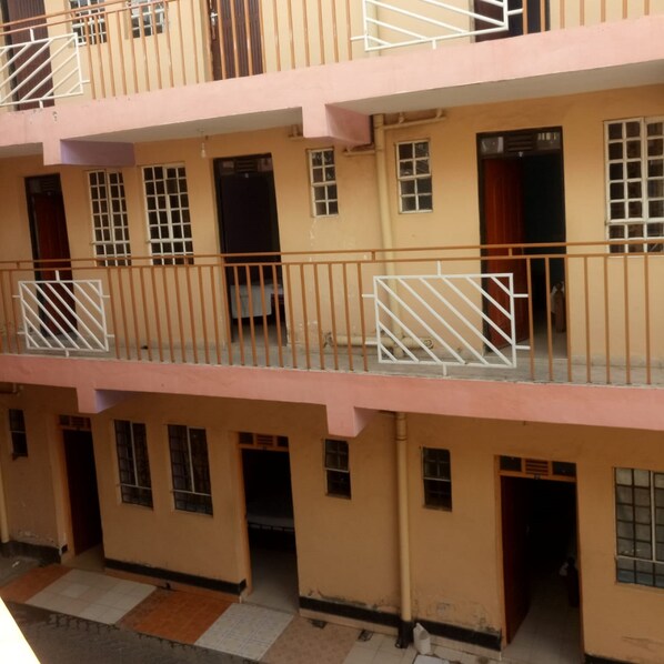 A multi-story building with balconies and windows.