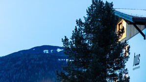 A building with a visible sign reading 'hws apartments' and a mountainous backdrop.
