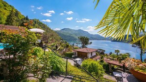 A hillside view of a lake with houses, a pool, and a gazebo. - Morcote Magic View (Morcote)