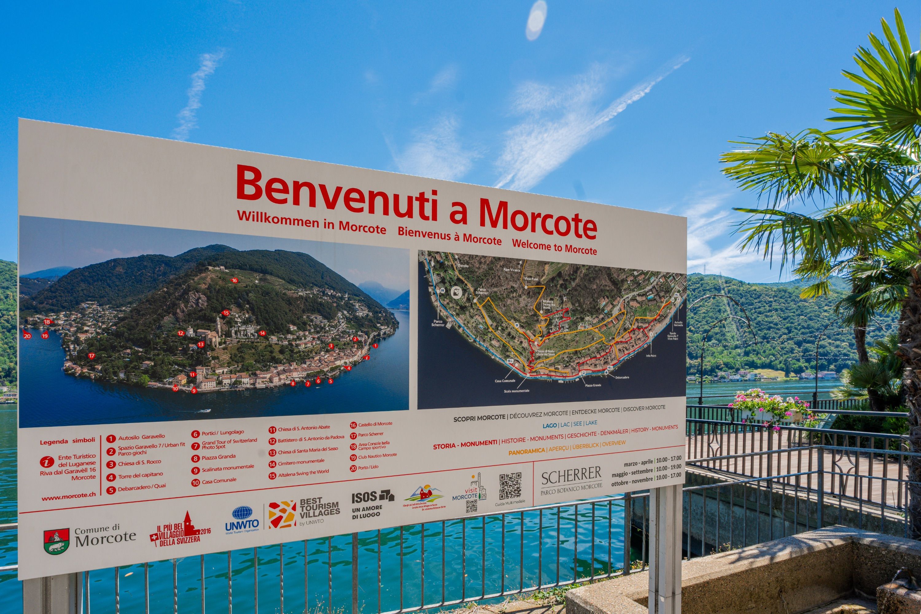 A welcome sign for Morcote with a map and symbols for tourist attractions.