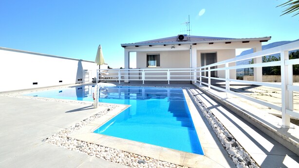 A rooftop swimming pool with a white railing, a building with a flat roof, and a clear blue sky. - Villa "White" with Private Pool, Terrace & Wi-Fi (Alcamo)