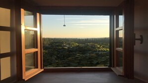An open window with a view of a landscape with trees and a clear sky. - Country House Bakicevo (Konavle)
