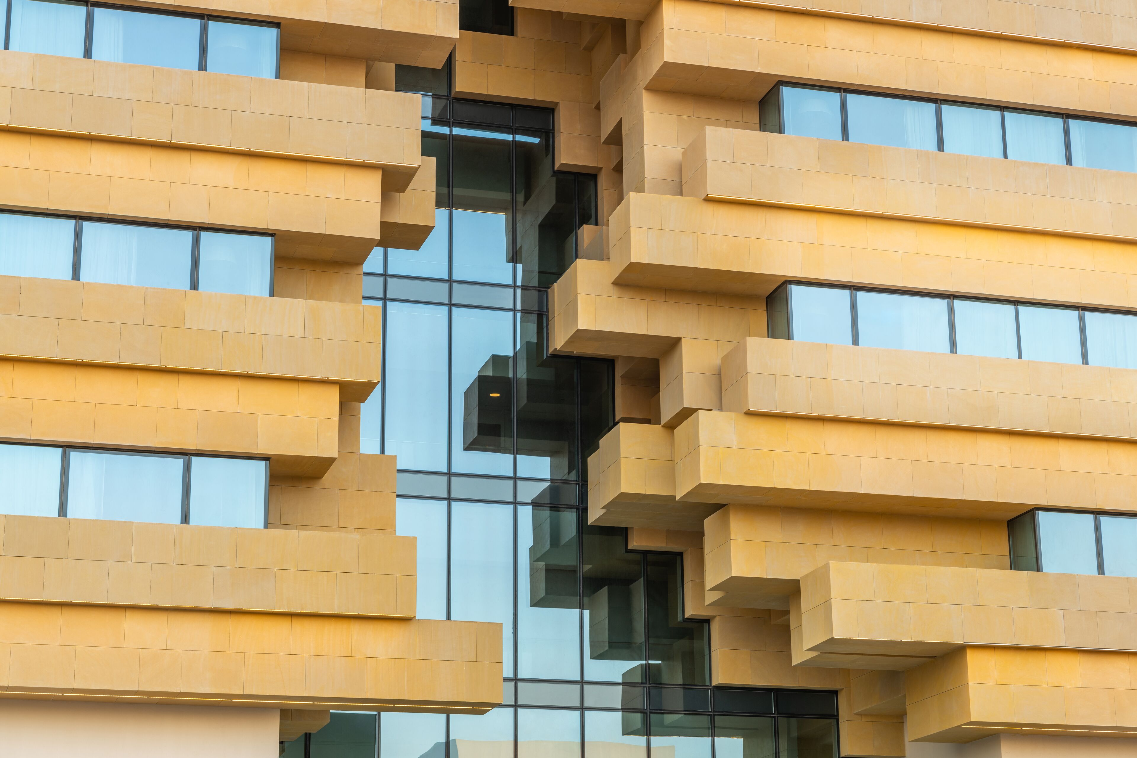 A modern building with a unique geometric facade and large windows.