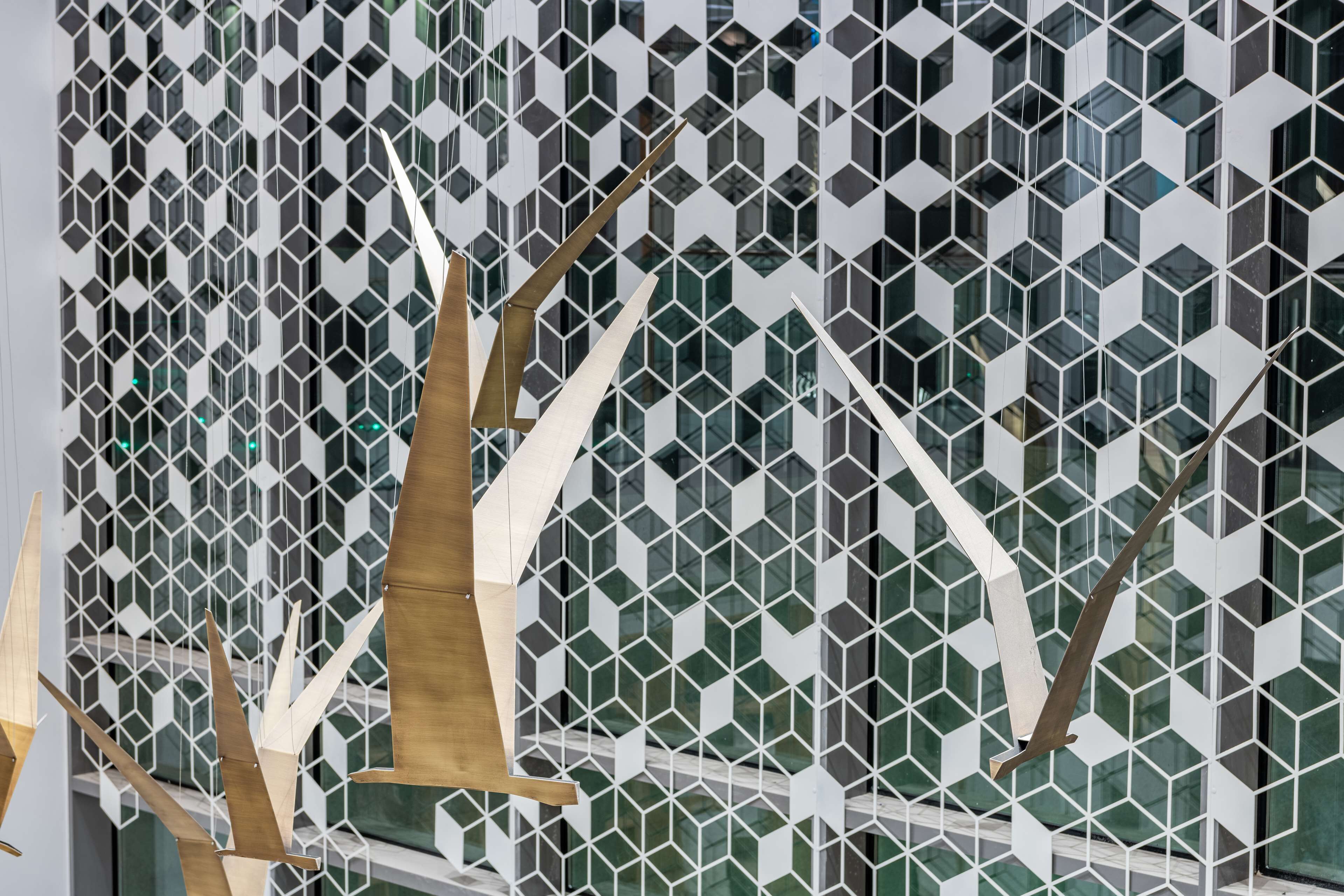 A modern building facade with a geometric pattern of hexagonal windows.