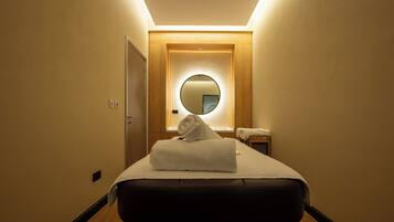 Simple, stylish accommodations with a single bed and a small nightstand.