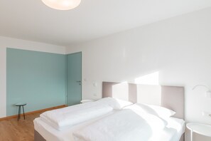 Une chambre d’hôtel avec un lit, une petite table et une table de chevet.