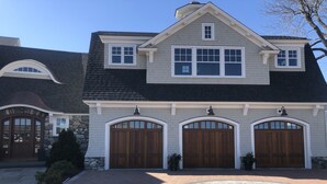 A two-story house with a brick driveway and a large star-shaped emblem in the center. - Breathtaking views of the Ocean, Incredible Sunrise, Sunsets and Jenness Beach (Rye)