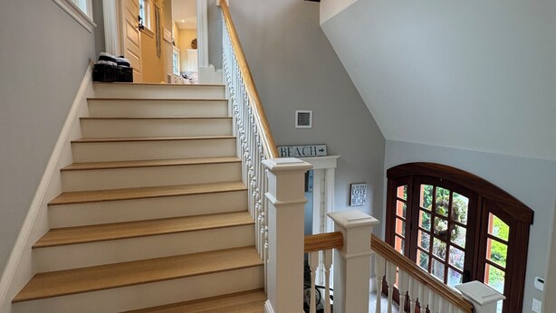 A staircase with wooden steps and white railings, leading to a landing with a sign that reads "BEACH". - Breathtaking views of the Ocean, Incredible Sunrise, Sunsets and Jenness Beach (Rye)