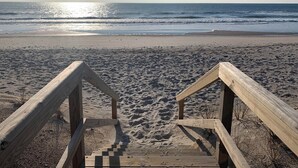 A wooden staircase leading to a sandy beach with the ocean in the background. - Oceanview Island Retreat with views of The Atlantic and Waterway (North Topsail Beach)