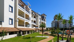A hotel with multiple balconies, a swimming pool, and a well-maintained garden. - El Faro 36 - Two Bedroom Apartment, Sleeps 5 (Punta del moral)