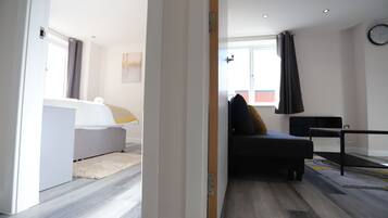 Deluxe Apartment | Living area | 50-inch flat-screen TV with cable channels, TV