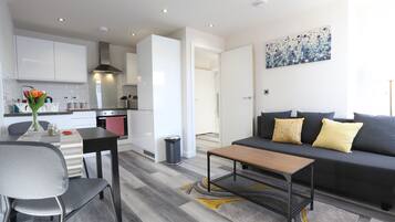 Deluxe Apartment | Living area | 50-inch flat-screen TV with cable channels, TV