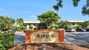A building with a sign reading "SeaWatch" and the number "201-231". - Inland Condo With Pool and Steps to Beach/food/shops (Marco Island)