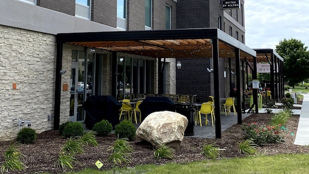 A modern hotel building with a sign reading "HOME 2" and "Suites by Hilton". - Home2 Suites by Hilton Carmel Indianapolis (Carmel)