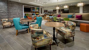 A modern interior with seating areas, tables, and a bar.